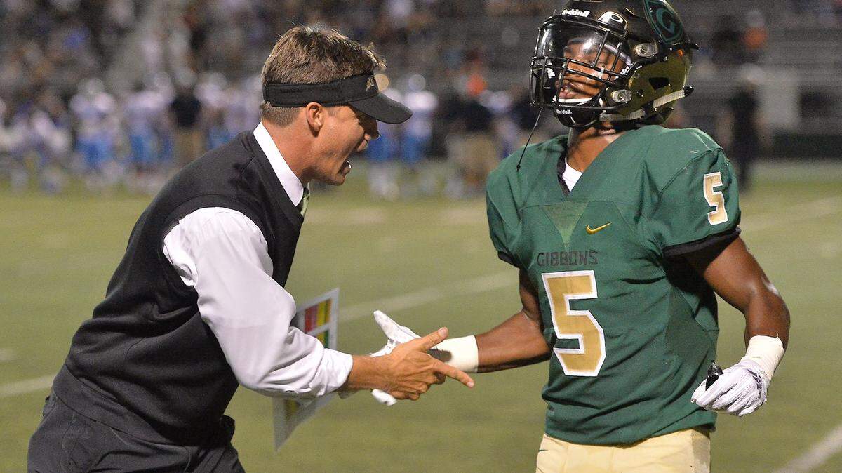 Cardinal Gibbons head coach Steven Wright congratulates Jacob Gill (5) after his touchdown. The Cardinal Gibbons Crusaders and the Cleveland Rams met in a non-conference football game in Raleigh, N.C. on September 7, 2018.