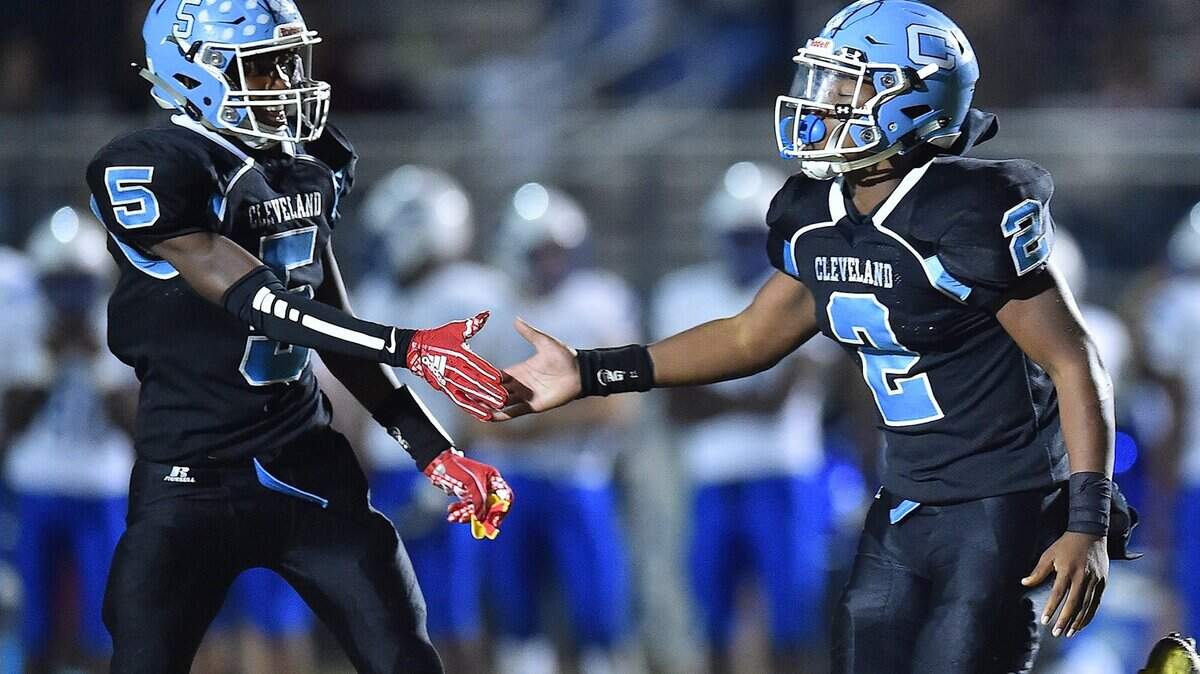 Cleveland’s Jon Barnes (5) congratulates Darius Ocean (2) after his touchdown late in the fourth quarter. The Clayton Comets and Cleveland Rams met in a regular season Greater Neuse River conference game in Clayton N.C. on October 19, 2018.