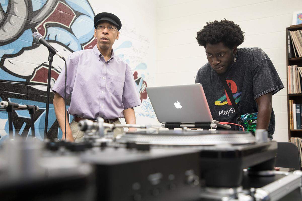 Kerwin Young, left, a musician and educator who guest instructed a beat making class at UNC-Chapel Hill’s Hip Hop Summer Institute, helps Daniel Odeh, right, a senior at UNC-Chapel Hill, pick out samples to work into his music on Wednesday, June 12, 2019.