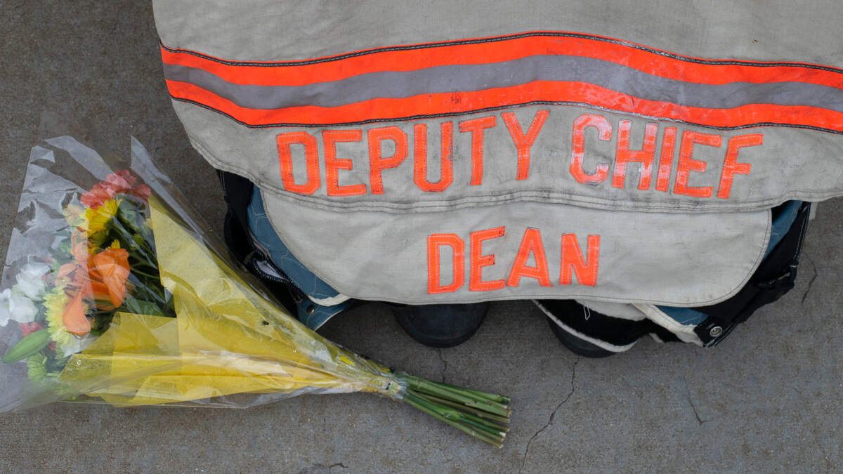 A bouquet of flowers honoring Clayton firefighter Jason Dean is placed beside his firefighting equipment at the Clayton Fire Department on Wednesday, September 23, 2020 in Clayton, N.C. Dean from COVID-19 complications on Wednesday, September 23, 2020 in Clayton, N.C.