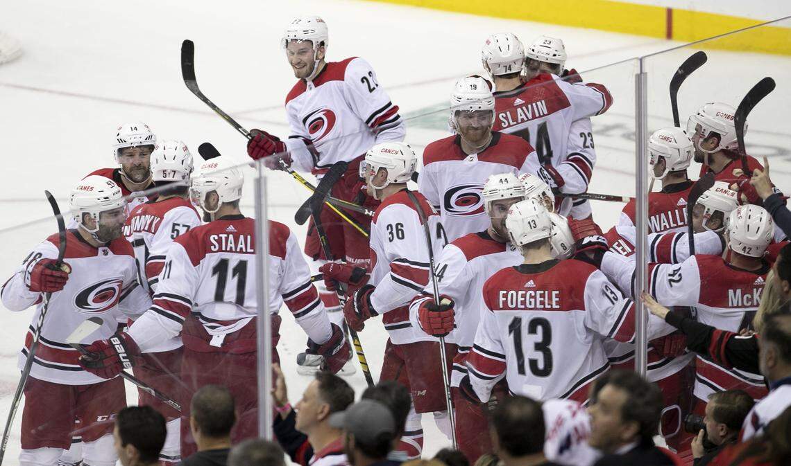 The Carolina Hurricanes surround Brock McGinn (23) after he scored the game winning goal in the second overtime to defeat the Washington Capitals 4-3 clinching their series with the Capitals on Wednesday, April 24, 2019 at Capital One Arena in Washington, D.C.