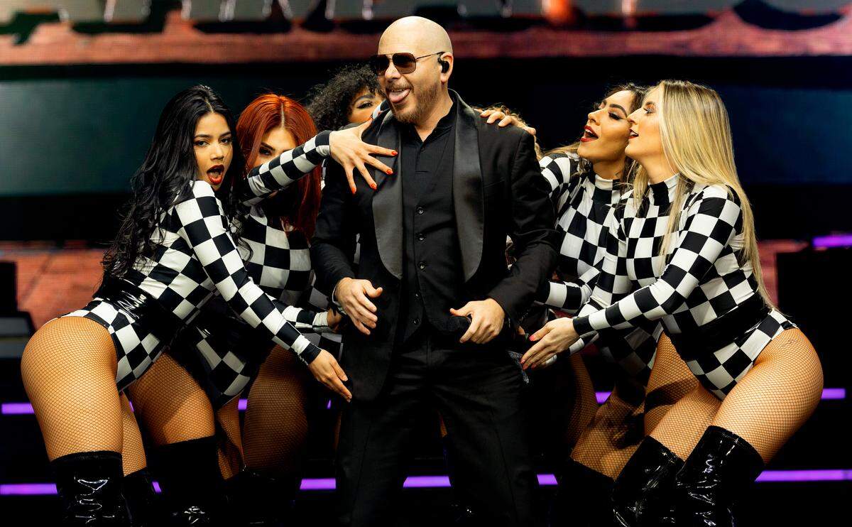 Pitbull and his dancers on stage during “The Trilogy Tour” at Raleigh, N.C.’s PNC Arena, Thursday night, Feb. 29, 2024.