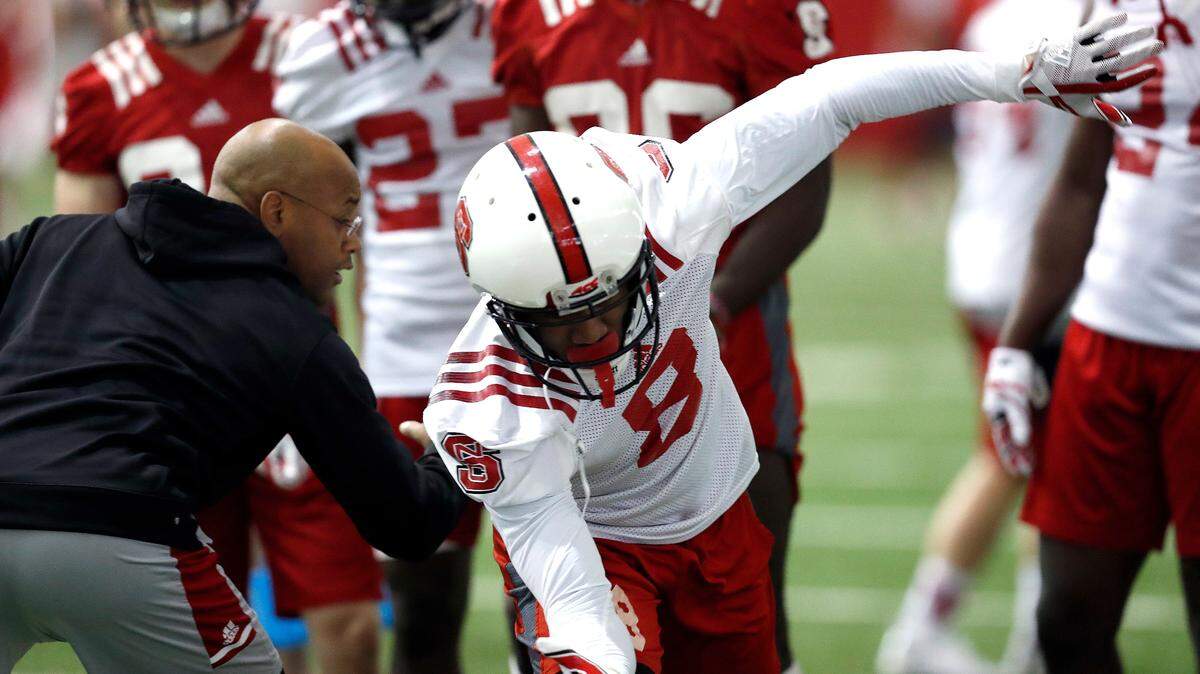 N.C. State’s Des Kitchings, left, runs through drills with the players including Maurice Trowell (8) during N.C. State football’s first spring practice at the Close-King Indoor Practice Facility in Raleigh, N.C., Sunday, Feb. 25, 2018.