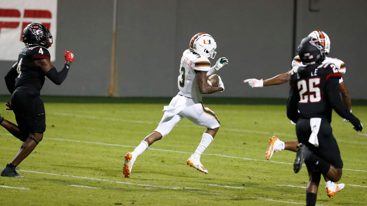 Miami wide receiver Mike Harley (3) runs on a 54-yard touchdown reception as N.C. State cornerback Cecil Powell (4) trails during a during the second half of Miami’s 44-41 victory over N.C. State at Carter-Finley Stadium in Raleigh, N.C., Friday, Nov. 6, 2020.