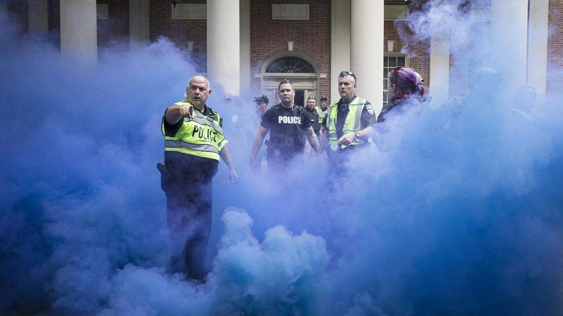 Police deployed smoke bombs into a crowd to disperse protesters after making arrests on the campus of the University of North Carolina campus in Chapel Hill, NC Saturday, Sept. 8, 2018. Supporters and opponents of the Silent Sam statue faced off again late Saturday afternoon on the UNC campus, yelling at each other at the base where the Confederate monument was toppled last month.