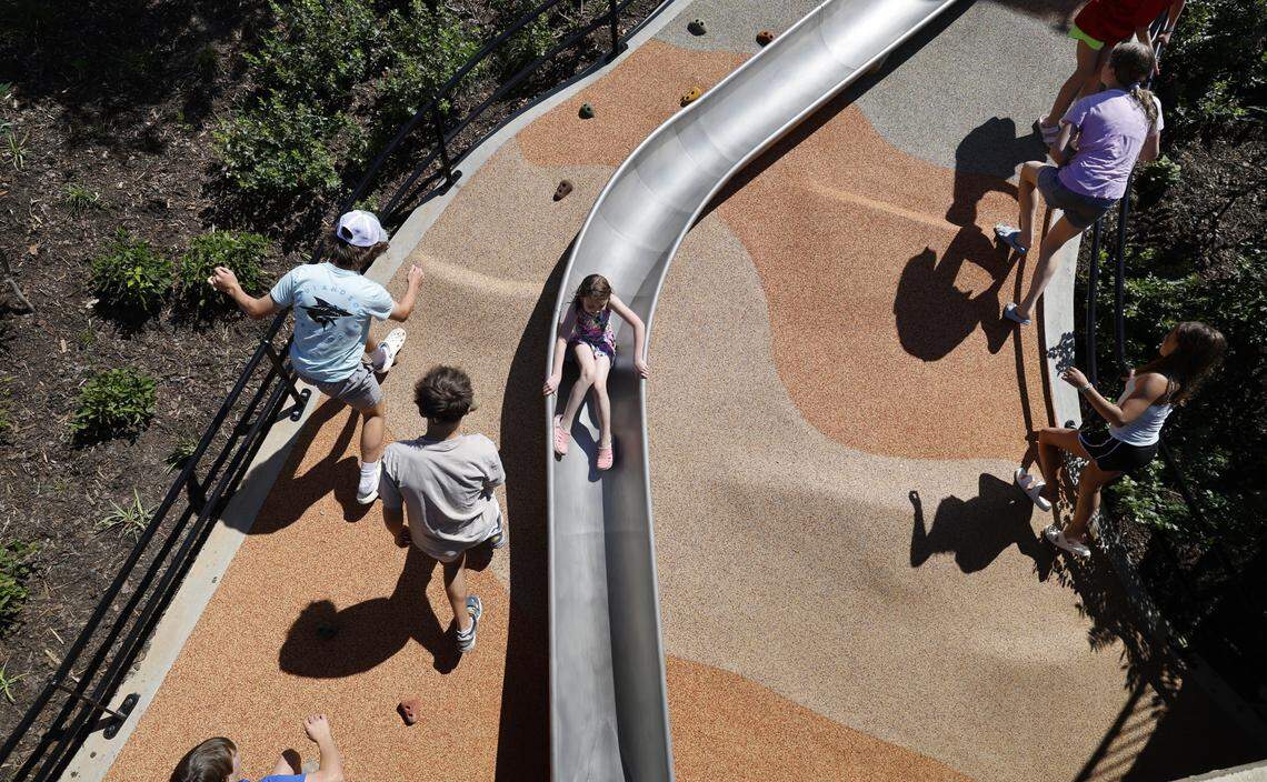 Attendees enjoy one of the slides at Gipson Play Plaza at Dix Park during a preview day Saturday.