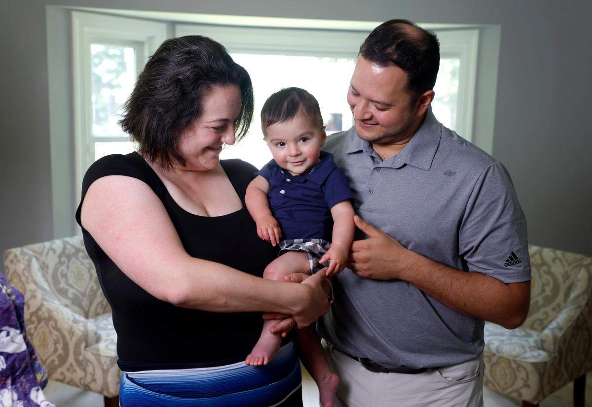 Stefanie Wisda, at ease here with her husband and young son, weathered a serious and unexpected life-threatening medical emergency the day Eli was born.