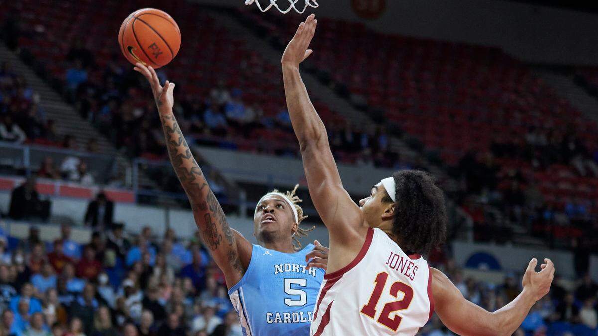 North Carolina forward Armando Bacot, left, shoots over Iowa State forward Robert Jones during the first half of an NCAA college basketball game in the Phil Knight Invitational tournament in Portland, Ore., Friday, Nov. 25, 2022. (AP Photo/Craig Mitchelldyer)