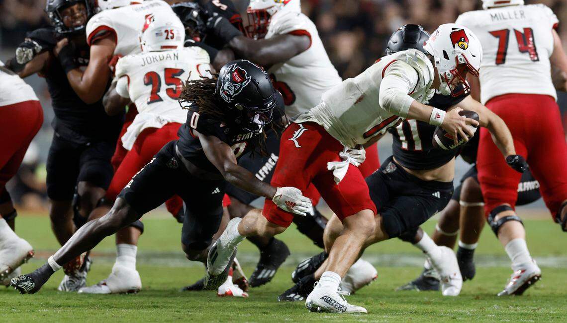N.C. State safety Sean Brown (0) sacks Louisville quarterback Jack Plummer (13) during the second half of Louisville’s 13-10 victory over N.C. State at Carter-Finley Stadium in Raleigh, N.C., Friday, Sept. 29, 2023.