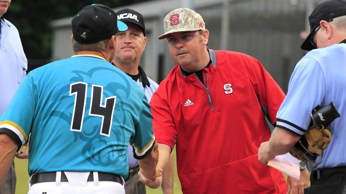 N.C. State associate coach Chris Hart greets Coastal Carolina head coach Gary Gilmore before their game in the Raleigh Regional of the NCAA Division I Men's Baseball Championship at Doak Field in Raleigh in June 2016. 