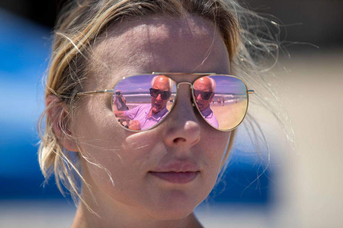 Robert Woodard, Chairman of the Dare County Commissioners is reflected in the sunglasses of NC 12 Task Force subcommittee member Kym Hunter from the Southern Environment Law Center, during a stop at one of the NC 12 hot spots in Buxton, N.C. on Tuesday, July 13, 2021.