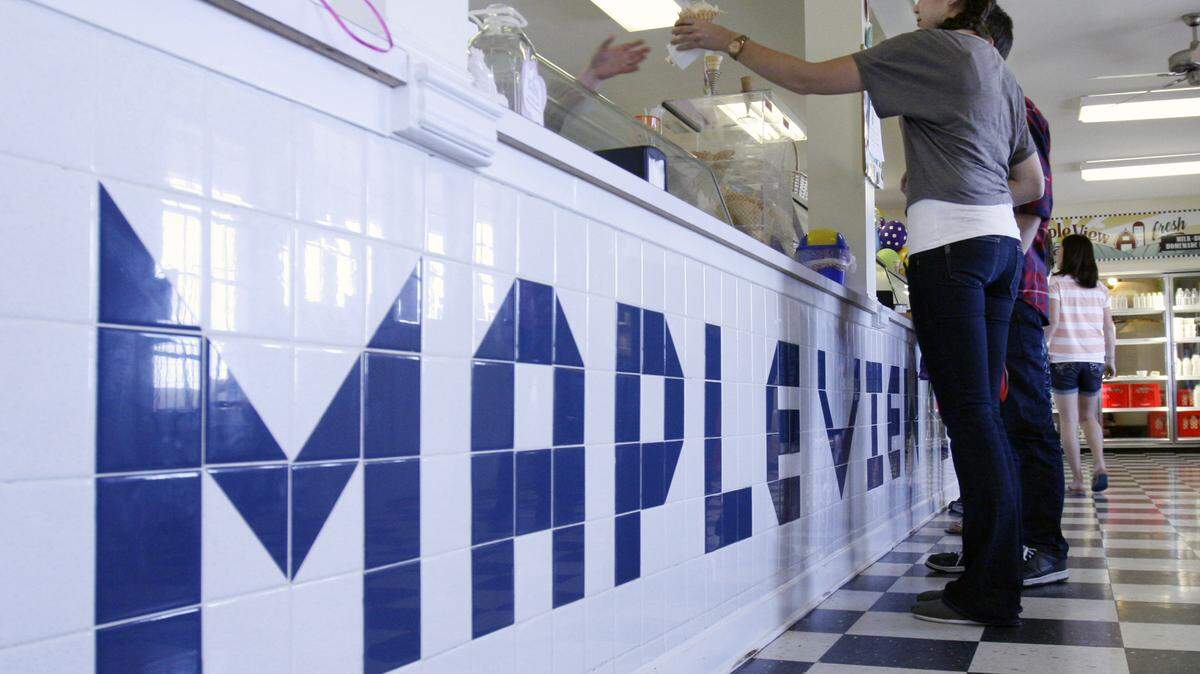 A server hands up an ice cream order to Kaia Parkinson during a warm spring day’s business at the Maple View Farm County Store in Orange county. Maple View Farm County Store was named winner of this year’s Best of Orange County 2013 Rose Awards in Exceptional Eats - Ice Cream.