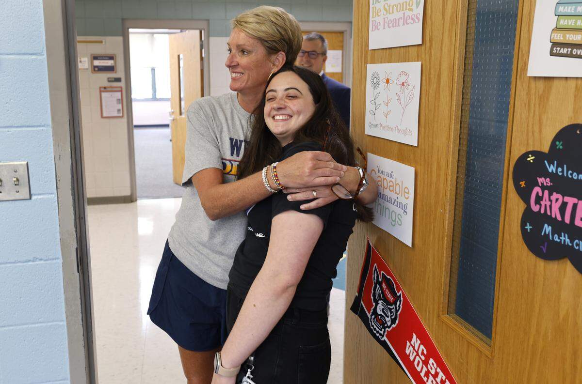 Dillard Drive Magnet Middle School principal Margaret Feldman gives new teacher Sarah Carter a hug after Carter was interviewed by the media in Raleigh, N.C., Thursday, August 21, 2025.