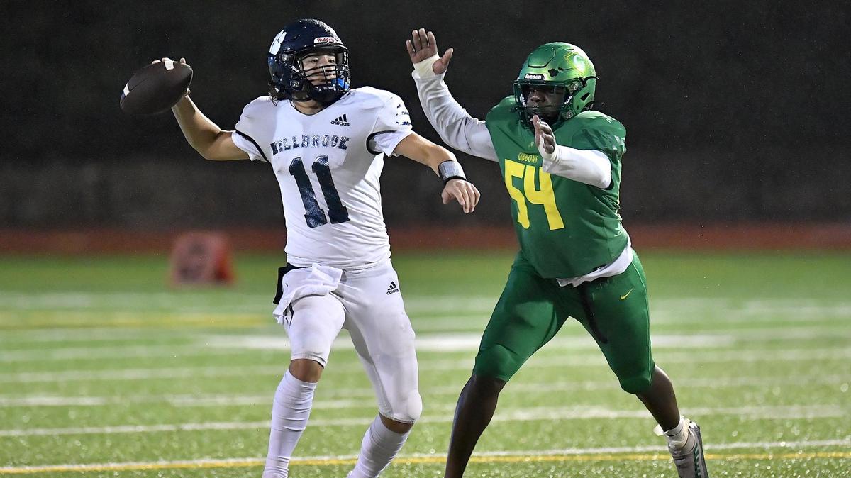 Millbrook quarterback Mason Fortune (11) looks to pass against the pressure from Cardinal Gibbons’ Ugonna Ezuma (54) during the second half. The Cardinal Gibbons Crusaders and the Millbrook Wildcats met in a NCHSAA 4A playoff game in Raleigh, NC on November 10, 2022