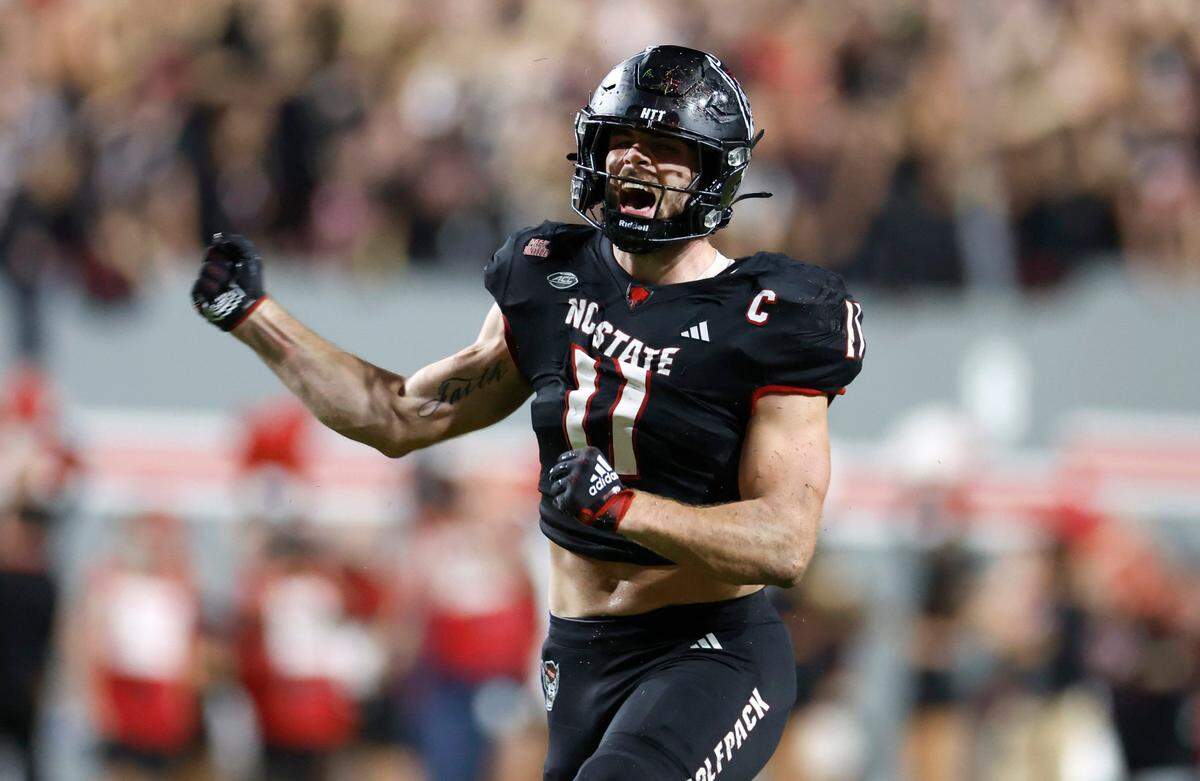 N.C. State linebacker Payton Wilson (11) celebrates recovering a Louisville fumble during their game at Carter-Finley Stadium on Friday, Sept. 29, 2023.