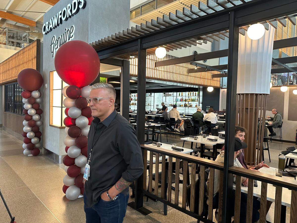 Triangle chef Scott Crawford in front of his restaurant, Crawford’s Genuine, in Terminal 2 at Raleigh-Durham International Airport. Taken Sept. 18, 2024.