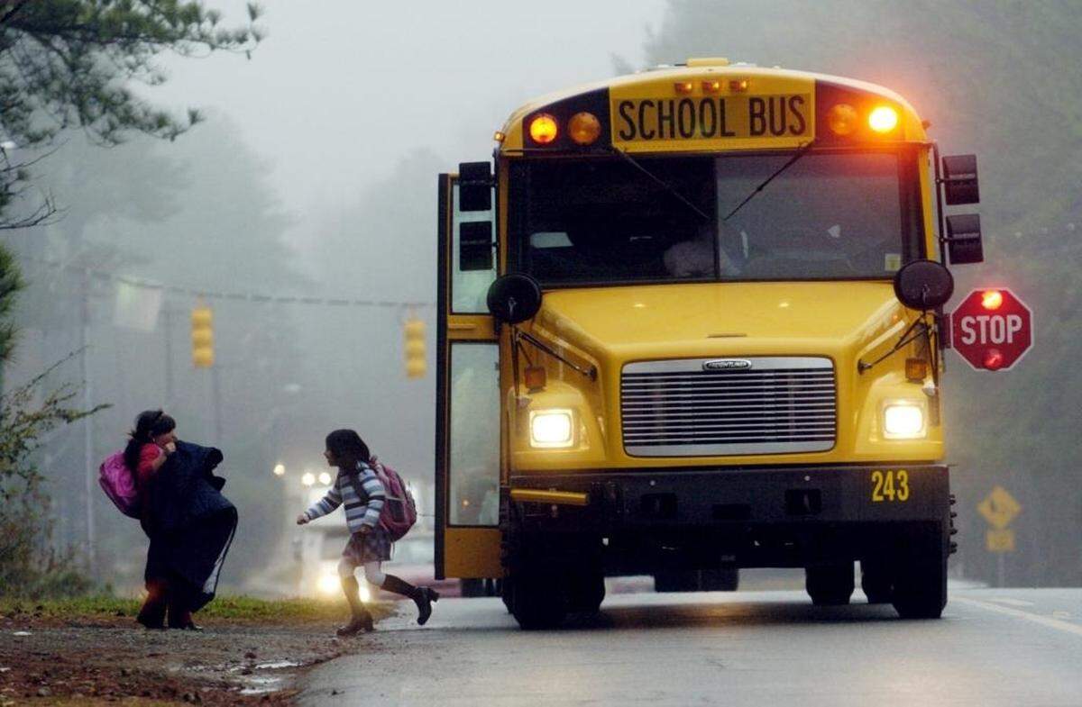 When a school bus stops for passengers in North Carolina — that is, to drop off or pick up passengers, and when the bus’s stop sign arm is used — whether you’re required to stop depends largely on how many lanes a road has.