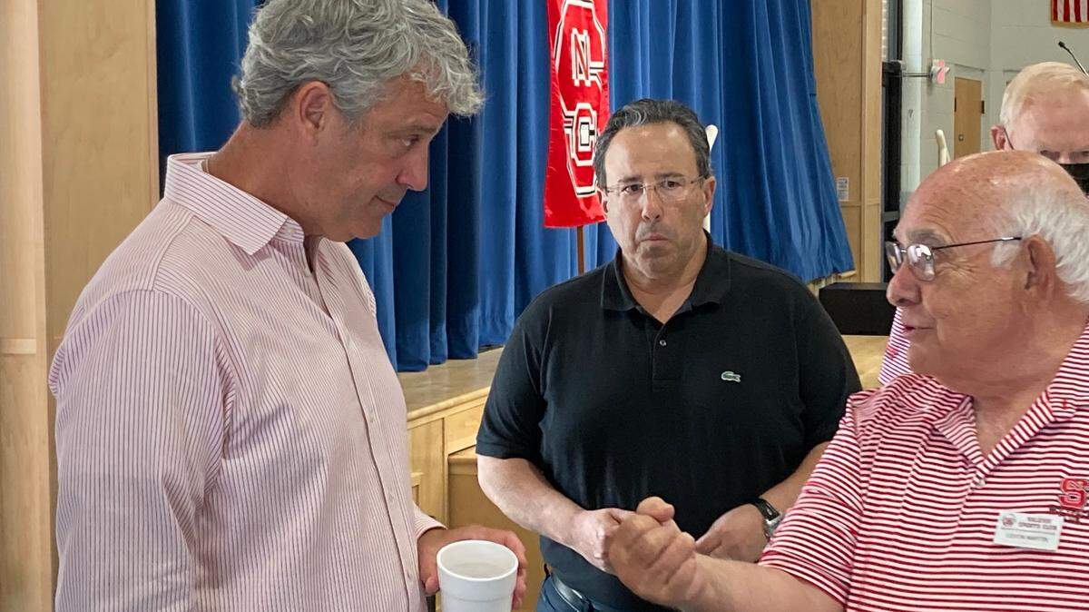 N.C. State athletic director Boo Corrigan, left, talks to Raleigh Sports Club members after being the guest speaker at the club on Wednesday, Sept. 8, 2021.