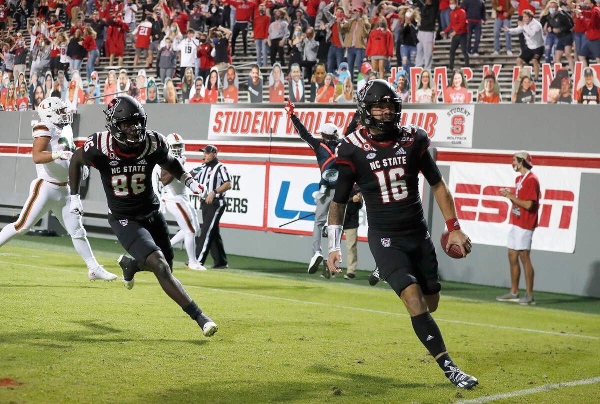 N.C. State quarterback Bailey Hockman (16) celebrates after scoring on a 31-yard touchdown reception during the first half of N.C. State’s game against Miami at Carter-Finley Stadium in Raleigh, N.C., Friday, Nov. 6, 2020.