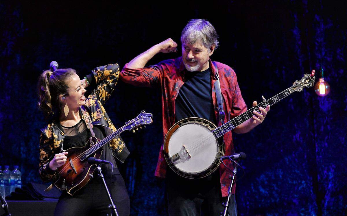 Sierra Hull and Bela Fleck bump elbows after a song at IBMA Bluegrass Live! at Raleigh, N.C.’s Red Hat Amphitheater, Friday night, Oct. 1, 2021.