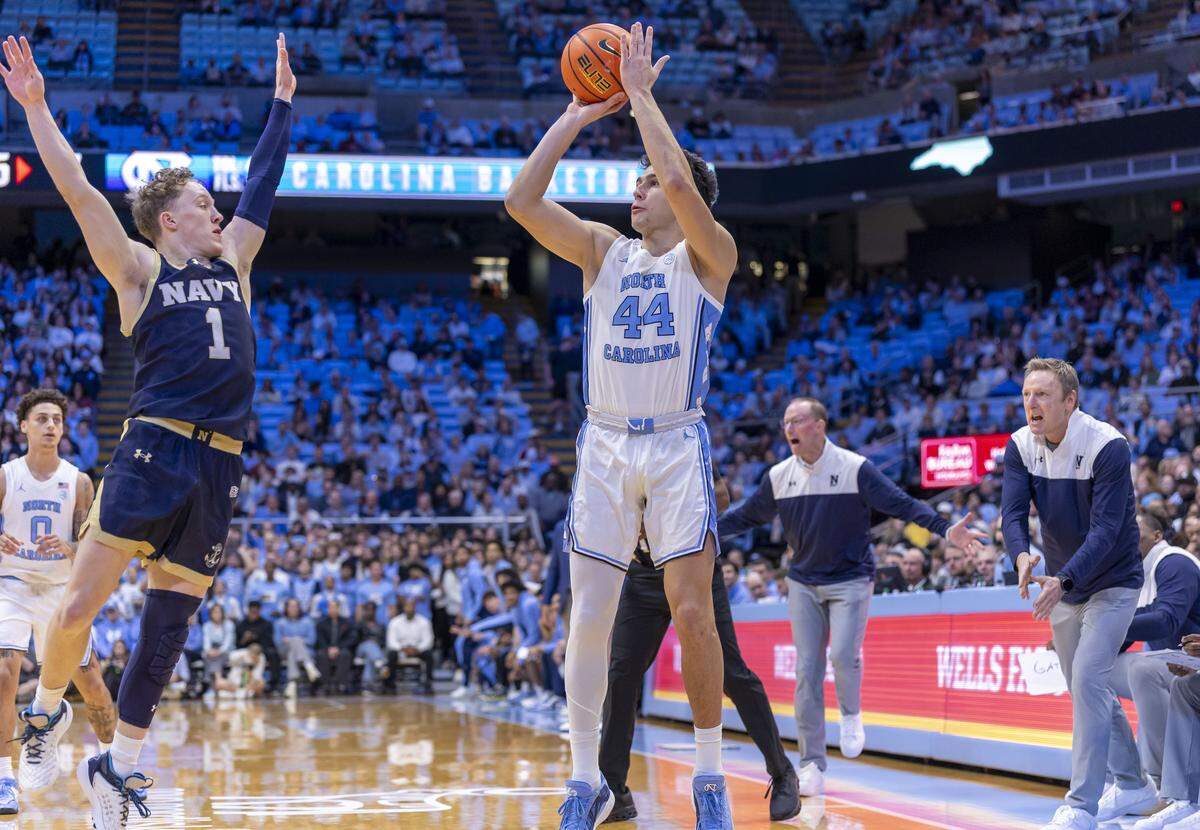 North Carolina guard Luka Bogavac (44) launches a three-point attempt over Navy guard Austin Benigni (1) in the first half on Tuesday, November 18, 2025 at the Smith Center in Chapel Hill, N.C. Bogavac was 3-6 from three-point range and scored 16 points in the Tar Heels’ 73-61 victory. 