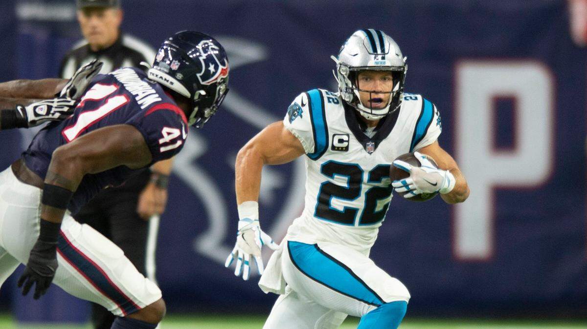 Panthers running back Christian McCaffrey, right, runs the ball during the game against the Texans at NRG Stadium on Thursday, September 21, 2021 in Houston, TX. McCaffrey suffered a hamstring injury during the second quarter and he did not return during the second half.