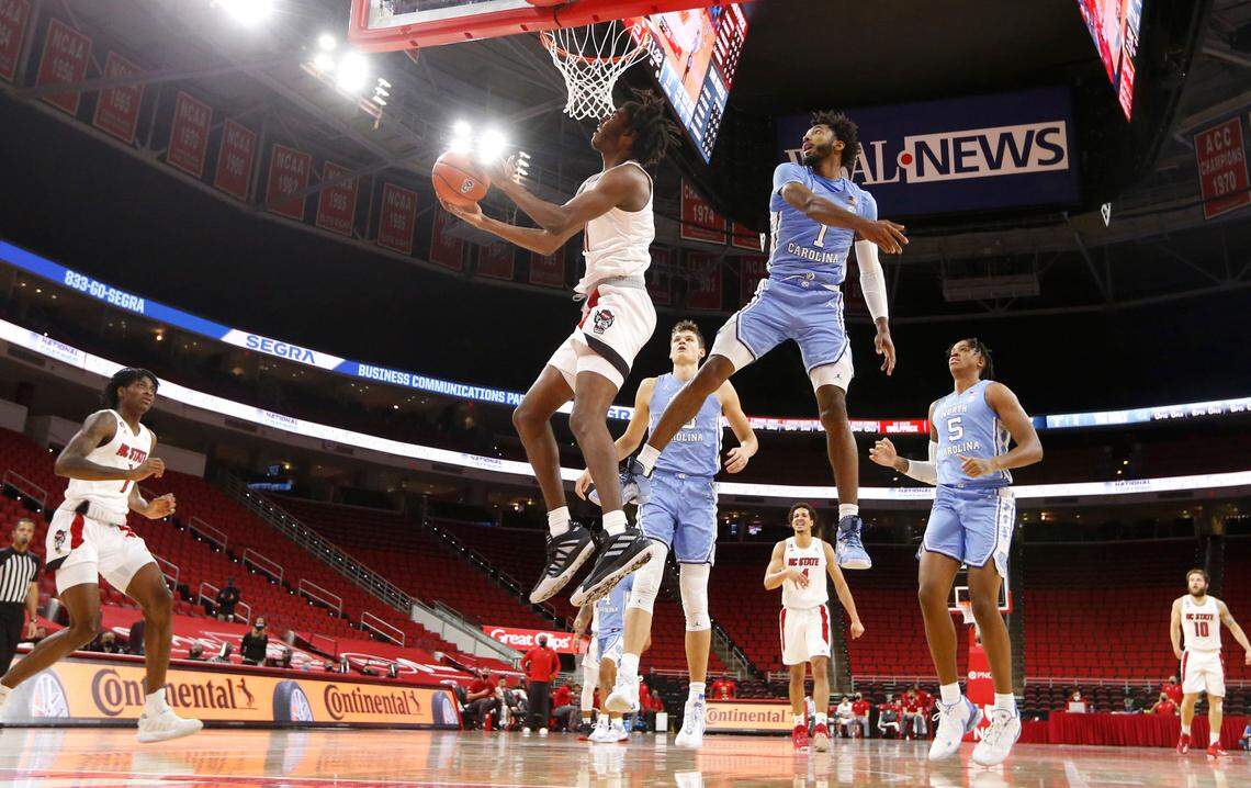 N.C. State’s Jaylon Gibson (11) looks to shoot as North Carolina’s Leaky Black (1) defends during N.C. State’s 79-76 victory over UNC at PNC Arena in Raleigh, N.C., Tuesday, December 22, 2020.
