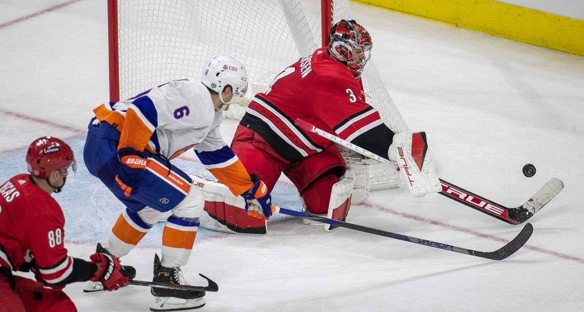 Carolina Hurricanes’ goalie Frederik Andersen (31) clears the puck after a shot attempt by New York Islanders’ Ryan Pulock (6) in the third period on Thursday, October 14, 2021 at PNC Arena in Raleigh, N.C.