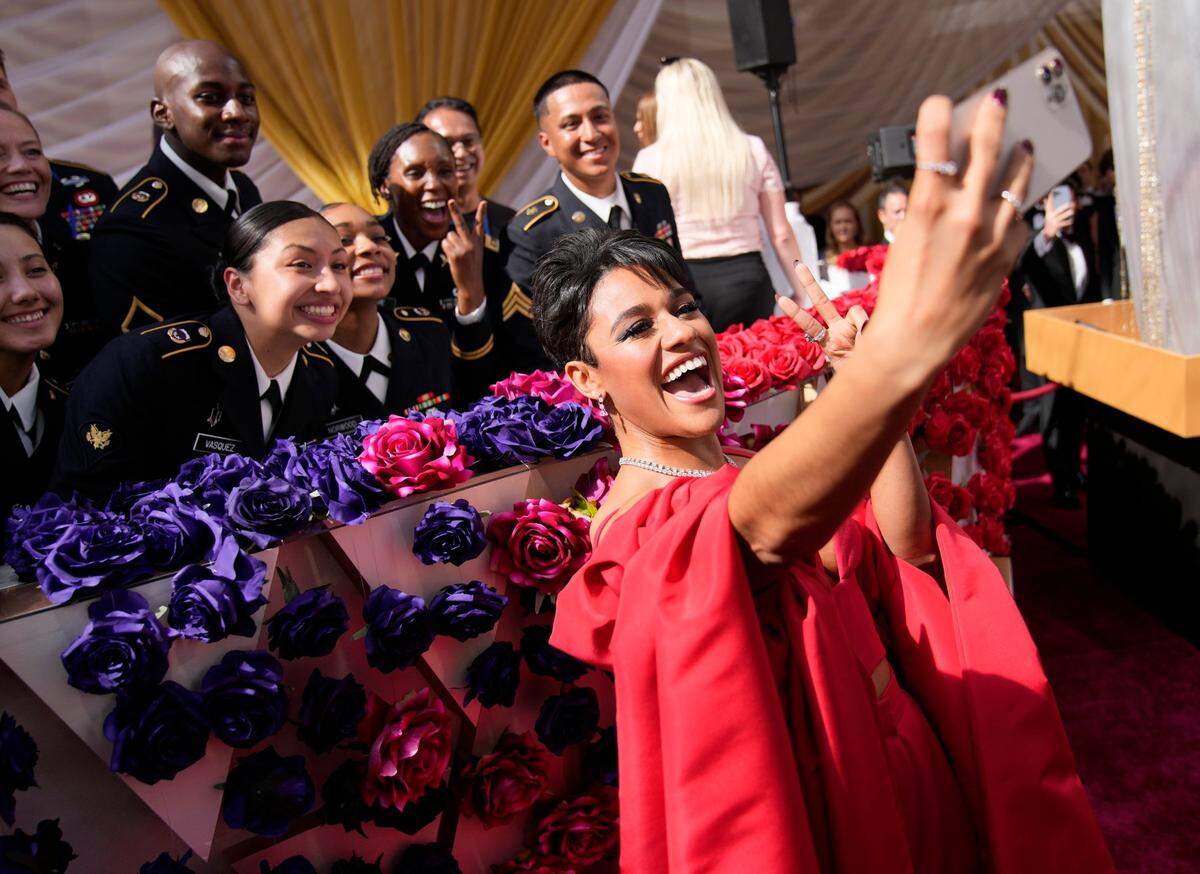 Ariana DeBose takes a photograph with members of the military at the Oscars on Sunday, March 27, 2022, at the Dolby Theatre in Los Angeles.