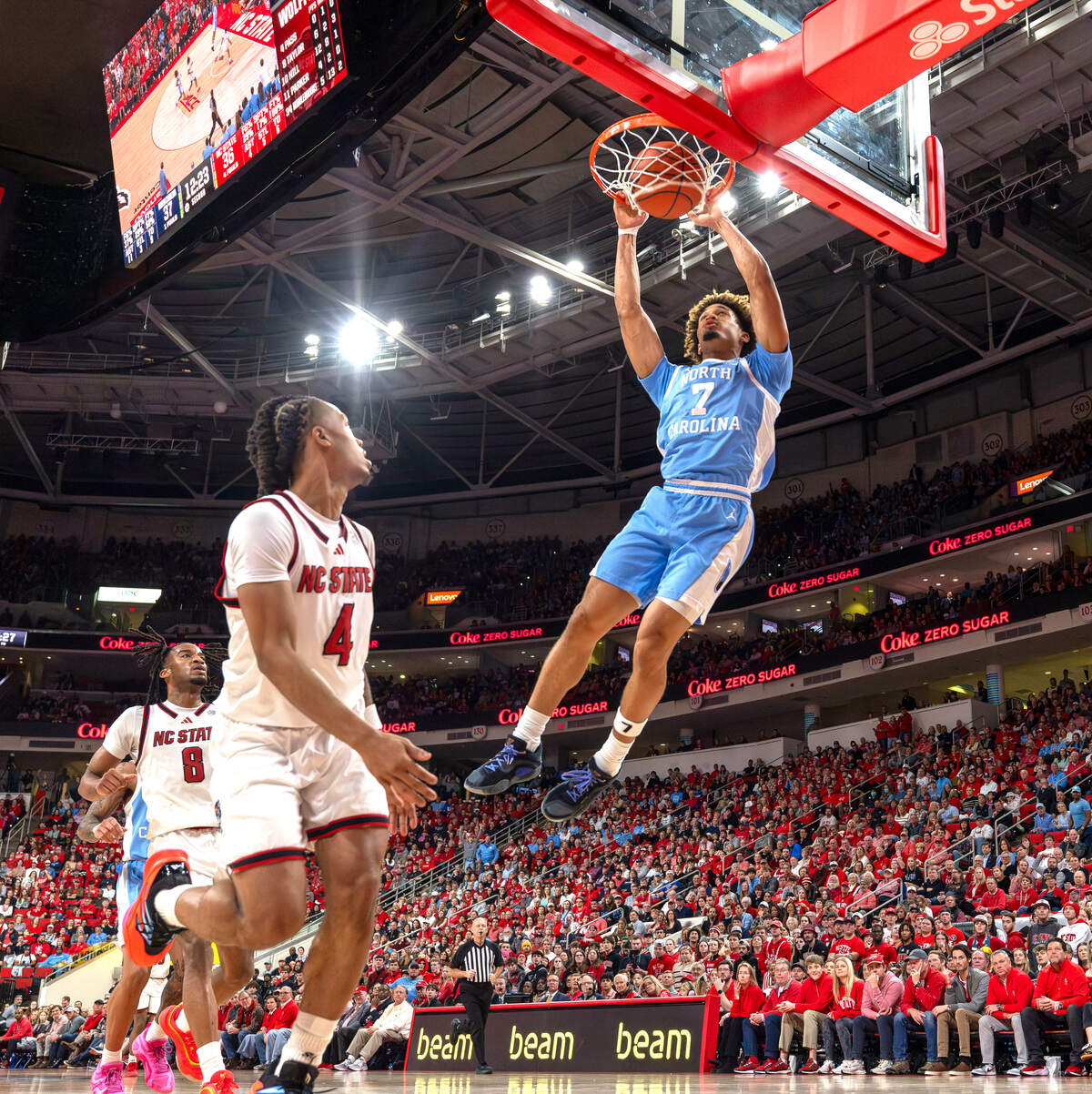 North Carolina guard Seth Trimble (7) breaks to the basket for a dunk over N.C. State’s Breon Pass (4) in the second half on Saturday, January 11, 2025 at Lenovo Center in Raleigh, N.C.