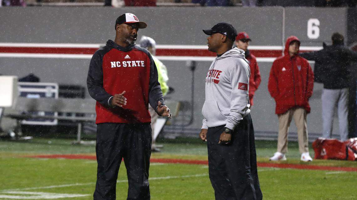 N.C. State co-offensive coordinators George McDonald, left, and Des Kitchings talks during warmups before N.C. State’s game against UNC at Carter-Finley Stadium in Raleigh, N.C., Saturday, November 30, 2019.