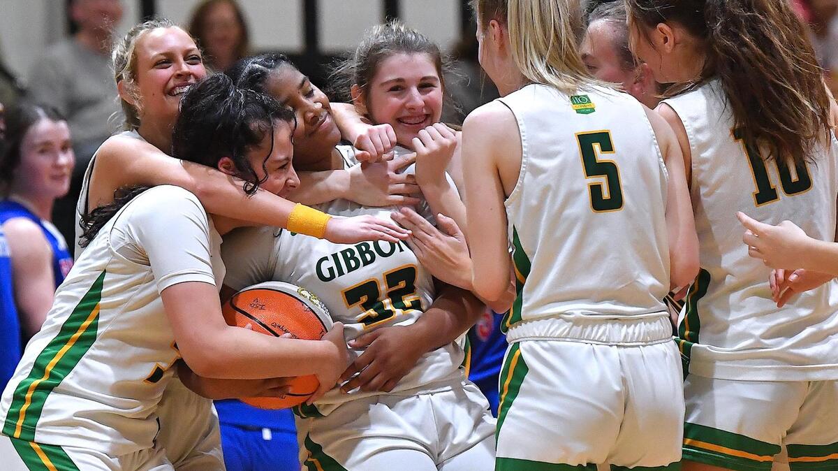 Rhian Lawrence (32) i congratulated by her Cardinal Gibbons teammates after scoring her 1000th point in her career. The Sanderson Spartans and the Cardinal Gibbons Crusaders met in a regular season basketball game in Raleigh, N.C. on February 10, 2023.