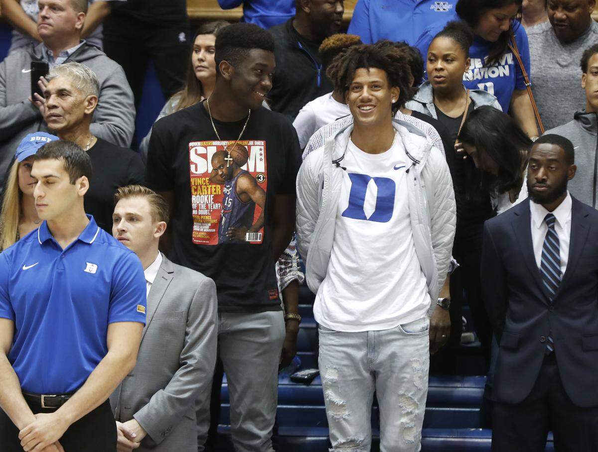 Mark Williams, left, and Jalen Johnson watch before Duke’s exhibition game against Northwest Missouri State in Durham, N.C., Saturday, Oct. 26, 2019.