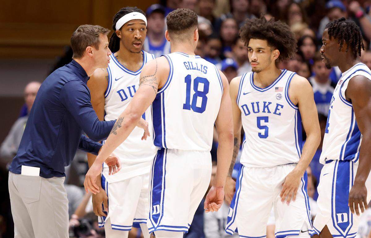 Duke head coach Jon Scheyer talks with Maliq Brown (6), Mason Gillis (18), Tyrese Proctor (5) and Sion James (14) during the Blue Devils’ game against Wofford at Cameron Indoor Stadium in Durham, N.C., Saturday, Nov. 16, 2024.