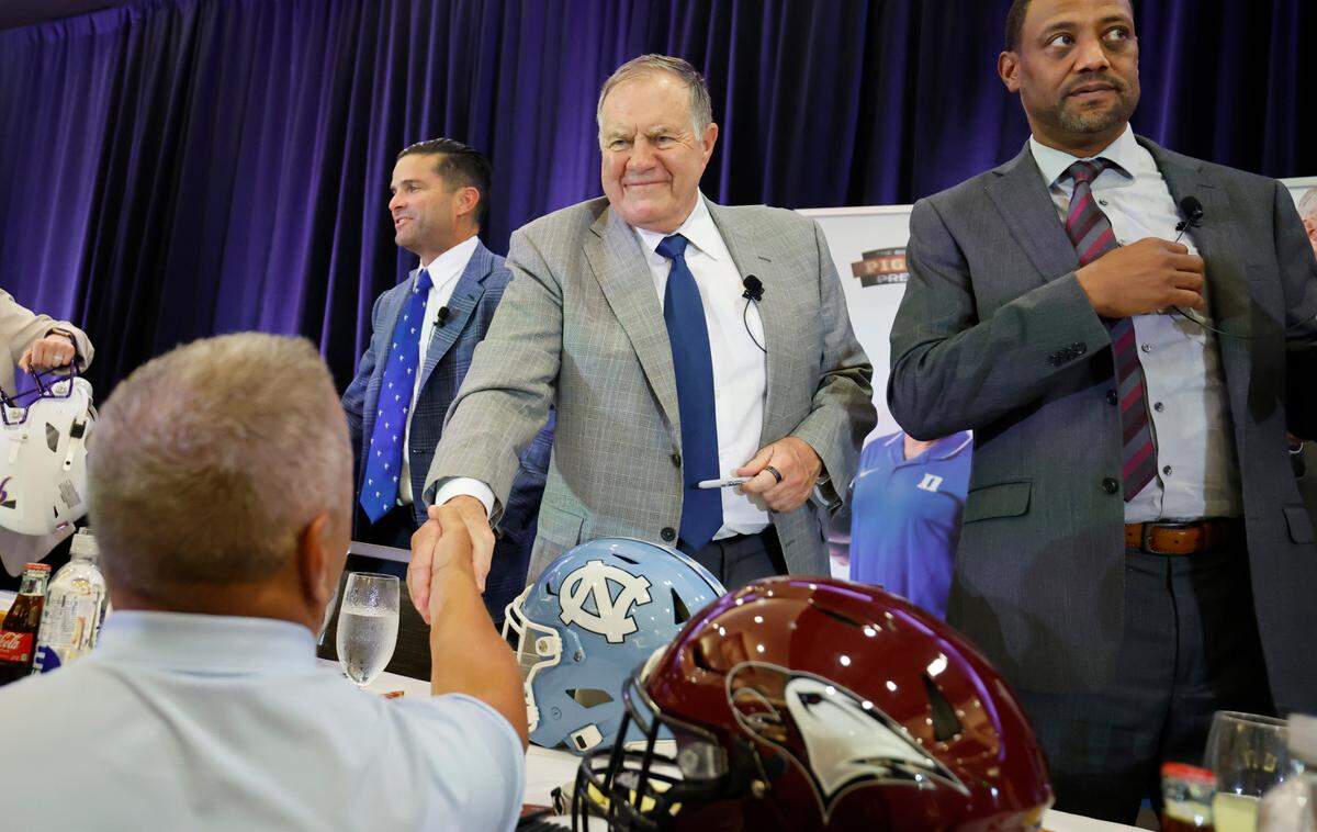 North Carolina head coach Bill Belichick greets fan after the Bill Dooley Pigskin Preview at the Hilton Raleigh North Hills on Friday, July 25, 2025. To the left is Duke head coach Manny Diaz and to the right is NCCU head coach Trei Oliver.