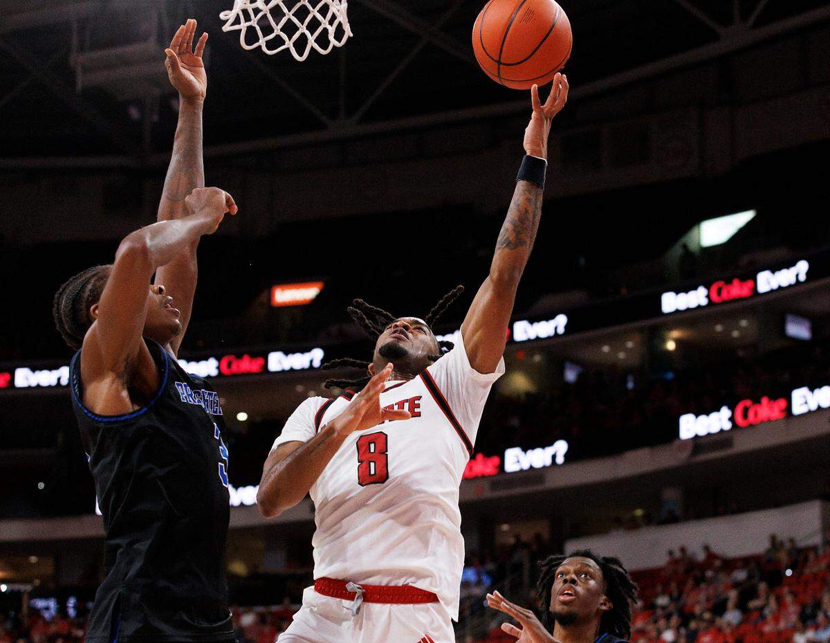 N.C. State’s Jayden Taylor drives to the basket past Presbyterian’s Kobe Stewart during the first half of the Wolfpack’s 81-72 win over Presbyterian on Friday, Nov. 8, 2024, at Lenovo Center in Raleigh, N.C.