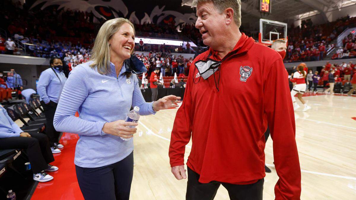 North Carolina head coach Courtney Banghart talks with N.C. State head coach Wes Moore before N.C. State’s game against UNC at Reynolds Coliseum in Raleigh, N.C., Thursday, January 6, 2022.