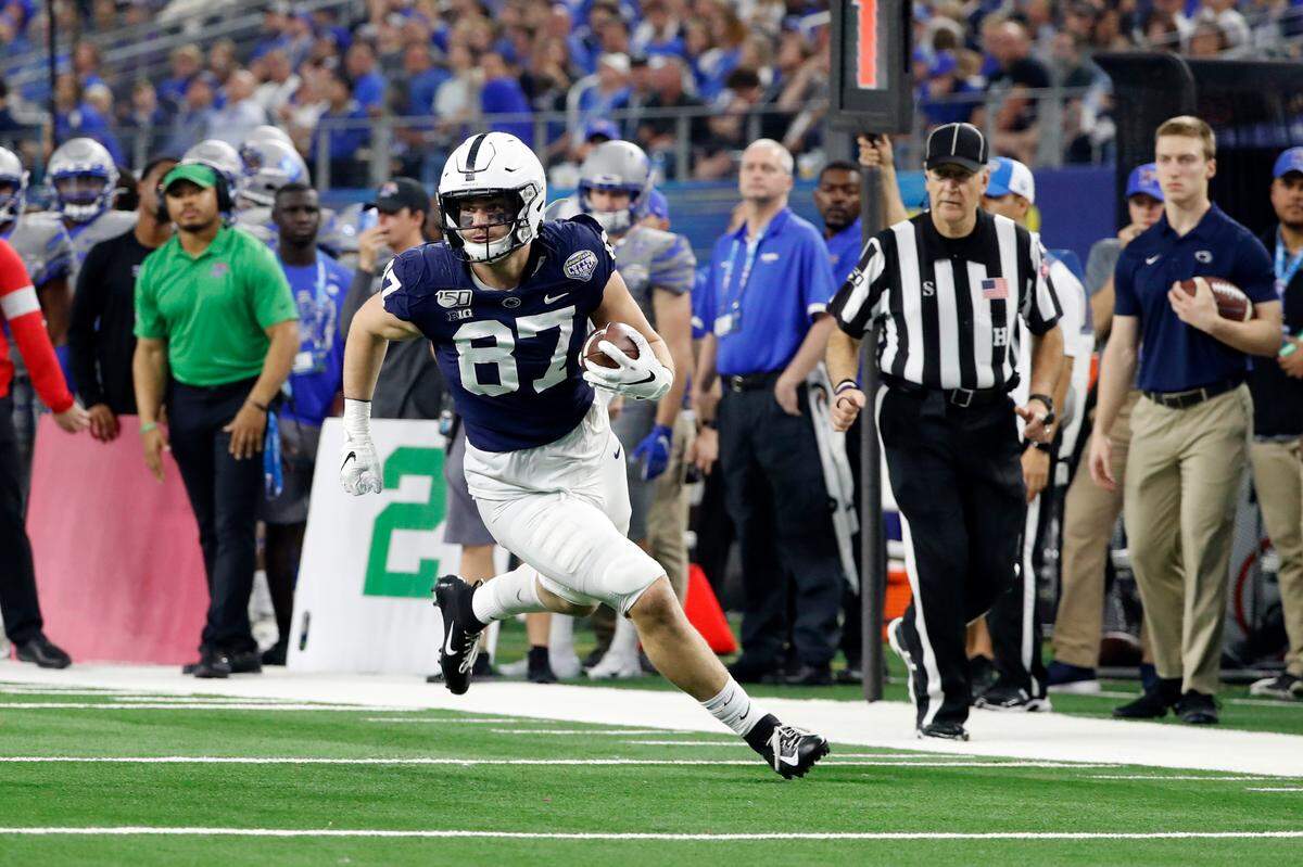 FILE - In this Dec. 28, 2019, file photo, Penn State tight end Pat Freiermuth (87) runs with the ball after a catch during the first half of the NCAA Cotton Bowl college football game against Memphis in Arlington, Texas. Freiermuth was selected to The Associated Press preseason All-America first-team, Tuesday, Aug. 25, 2020. (AP Photo/Roger Steinman, File)