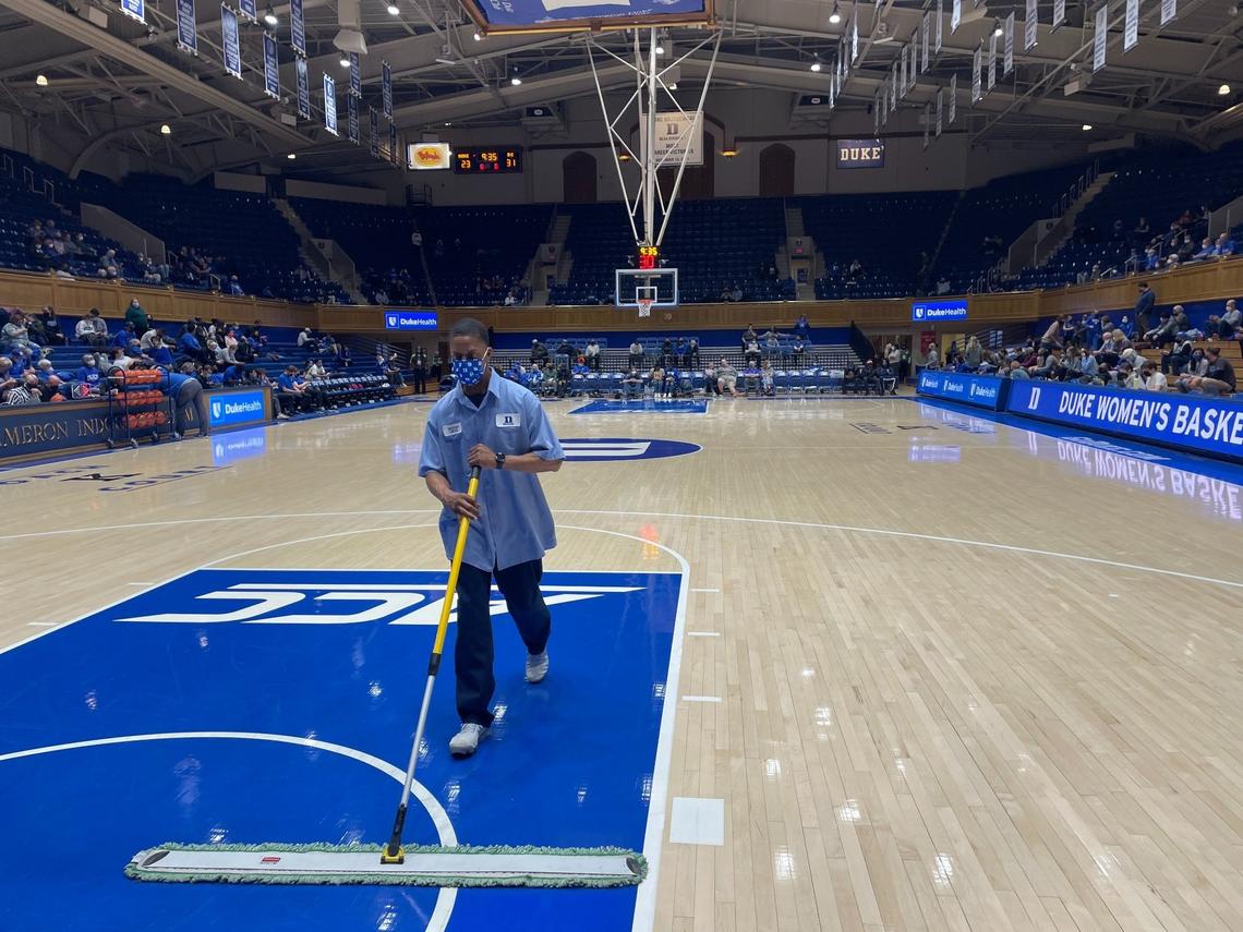 William Harris sweeps the court at Cameron Indoor Stadium at halftime of the Duke women’s basketball game against Boston College on Feb. 24, 2022. Harris, a Duke facilities worker, has been responsible for keeping Cameron clean for almost a decade.