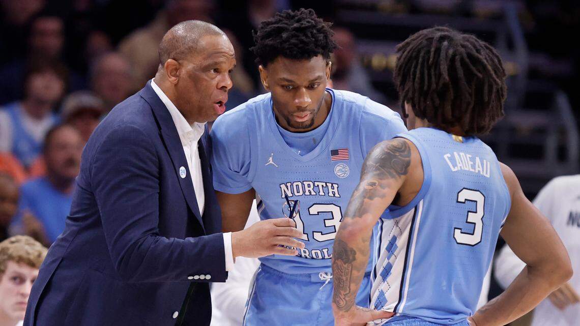 UNC coach Hubert Davis tries to rally the Tar Heels as he gives instructions to Jalen Washington and Elliot Cadeau in the second half against Duke in the ACC Tournament.