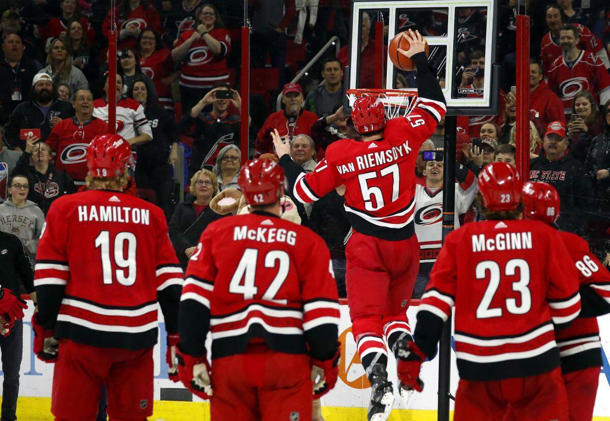 Carolina Hurricanes’ Trevor van Riemsdyk (57) dunks a basketball during a celebration after the team’s win over the Minnesota Wild, Saturday, March 23, 2019, in Raleigh, N.C.