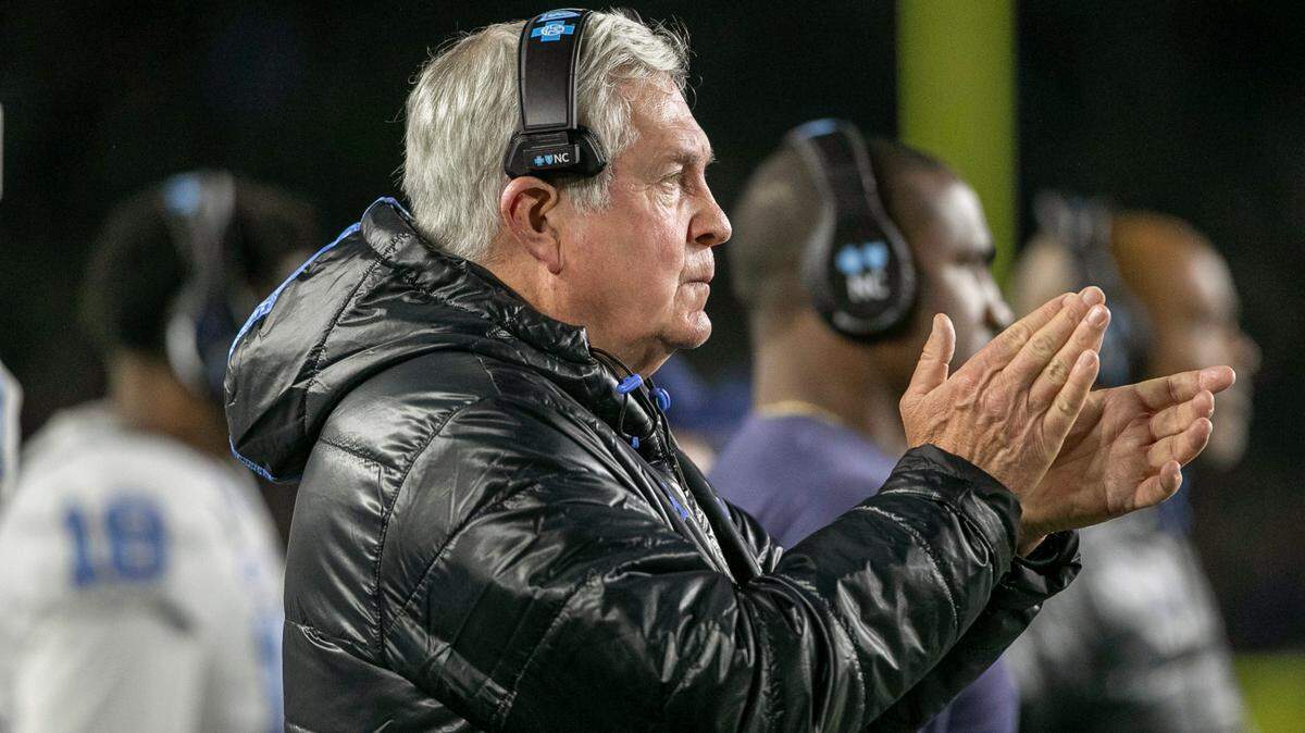 North Carolina coach Mack Brown applauds his defensive unit after stopping Notre Dame in the first quarter on Saturday, October 30, 2021 in South Bend, Ind.