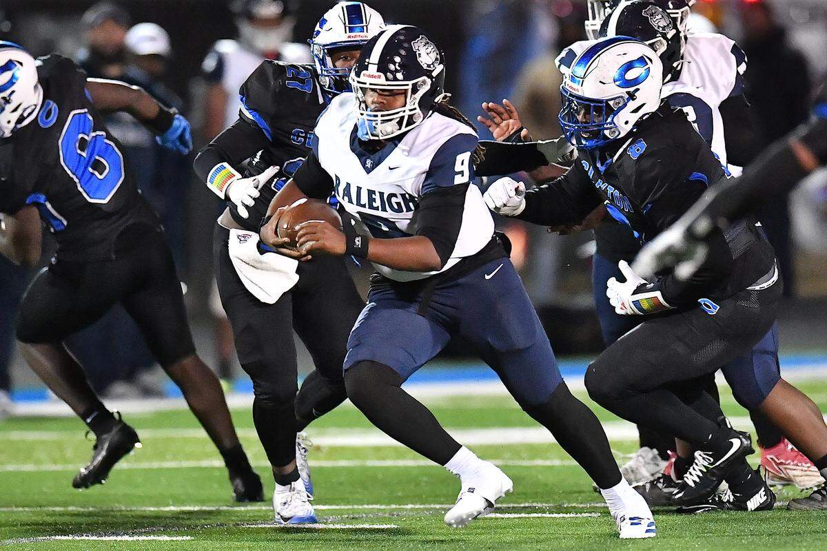 Southeast Raleigh quarterback James McCullers (9) scrambles for yardage ahead of the Clayton defense during the second half. The Clayton Comets and the Southeast Raleigh Bulldogs met in the fourth round of the NCHSAA 7A Playoffs in Clayton, N.C. on November 28, 2025.