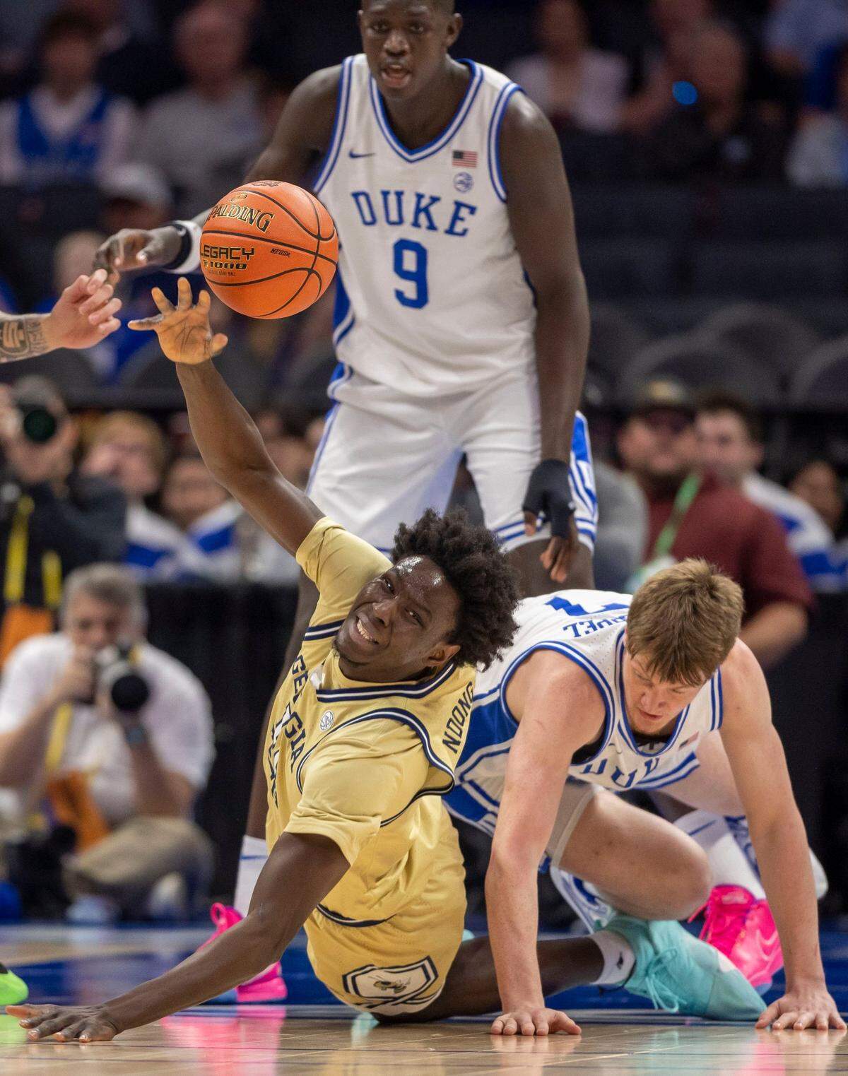 Georgia Tech’s Baye Ndongo (11) recovers a loose ball against Duke’s in the first half against Georgia Tech on Thursday, March 13, 2025 during the quarterfinals of the ACC Tournament at Spectrum Center in Charlotte, N.C.