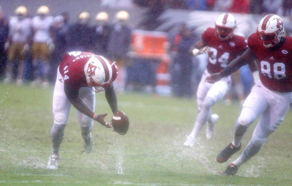 N.C. State’s Dexter Wright (14) pulls up the loose ball after Pharoah McKever (88), right, blocked the punt during the second half of N.C. State’s 10-3 victory over Notre Dame at Carter-Finley Stadium in Raleigh, N.C., Saturday, Oct. 8, 2016.