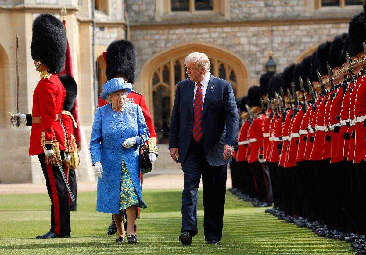 President Donald Trump with Queen Elizabeth II, inspecting the Guard of Honour at Windsor Castle in Windsor, England in 2018.