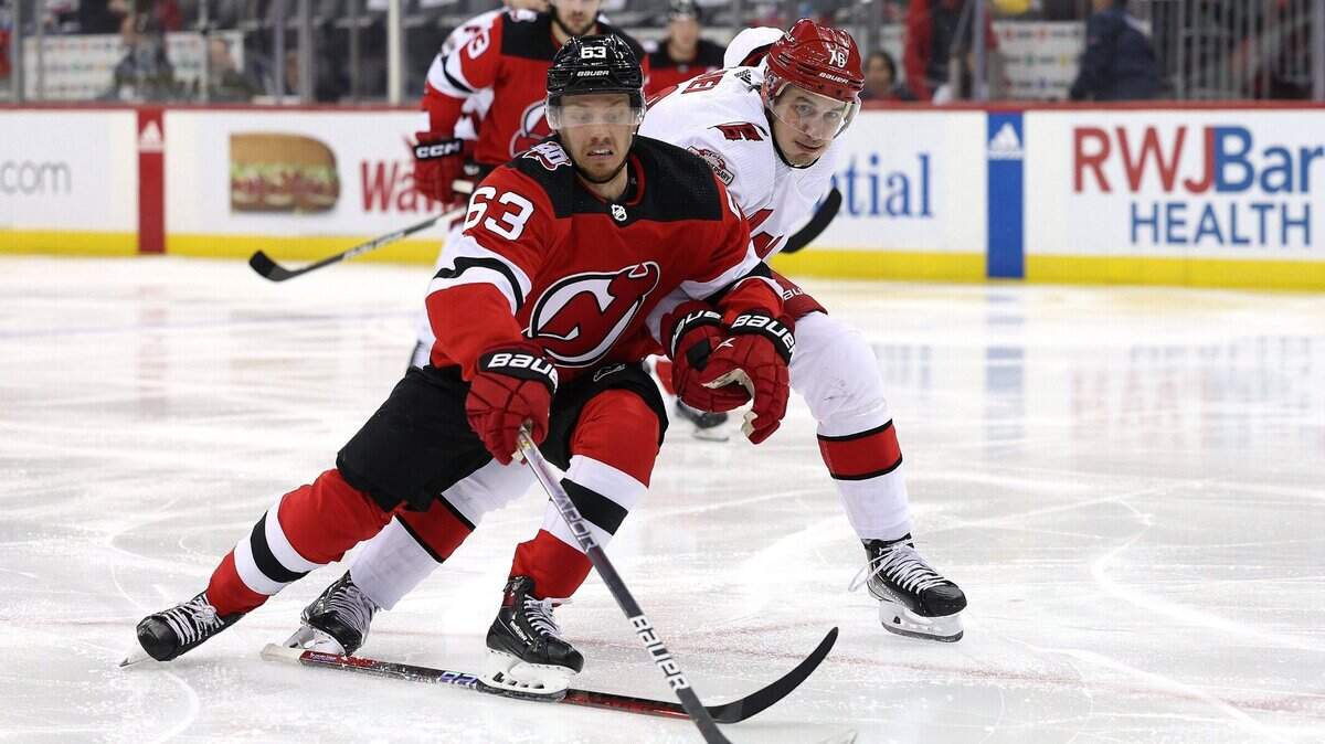 Jesper Bratt (63) of the New Jersey Devils takes the puck as Brady Skjei (76) of the Carolina Hurricanes defends during the second period in Game Three of the Second Round of the 2023 Stanley Cup Playoffs at Prudential Center on Sunday, May 7, 2023, in Newark, New Jersey. (Elsa/Getty Images/TNS)