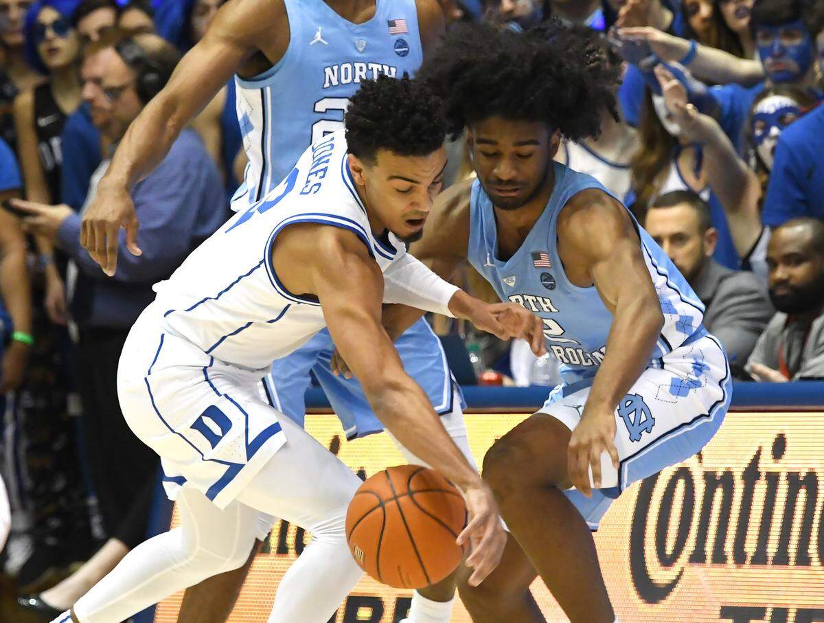 Duke guard Tre Jones (3) and UNC guard Coby White (2) battle for the ball in the first half. Duke battled UNC at Cameron Indoor Stadium In Durham, N.C., Wed., Feb.20, 2019.