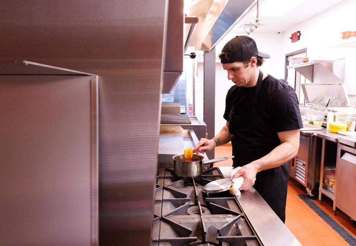 Executive chef Zack Gragg works in the kitchen of Mala Pata during the restaurant’s soft opening on Tuesday, May 6, 2025, in Raleigh, N.C.