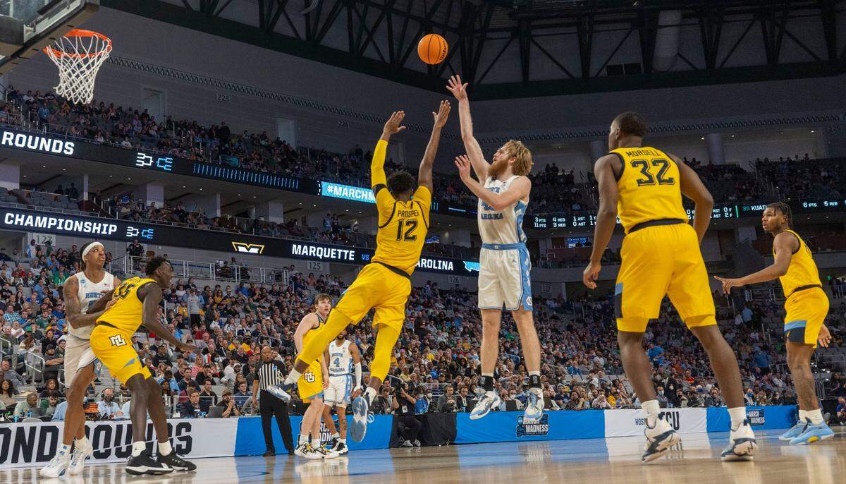 North Carolinas Brady Manek (45) launches a three-point shot in the second half against Marquettes Olivier-Maxence Propser (12) on Thursday, March 17, 2022 during the NCAA Tournament at Dickies Arena in Ft. Worth, TX. Manek lead all scores with 28 points in the Tar Heels 95-63 victory. Manek was 5-10 from the three point line.